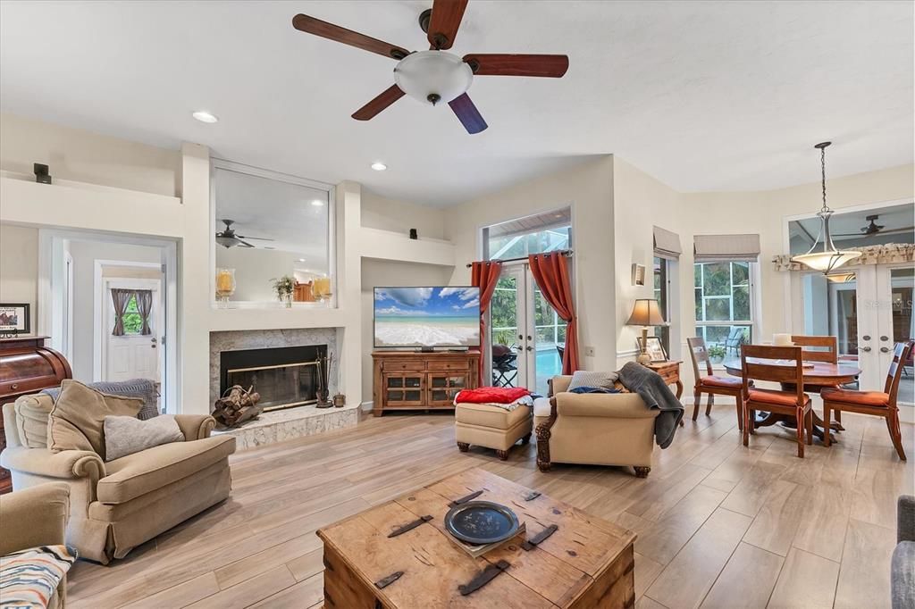 Dining room, Fireplace, Interior, Living room, Pendant Lights, Recessed Lighting, Wood Texture Flooring