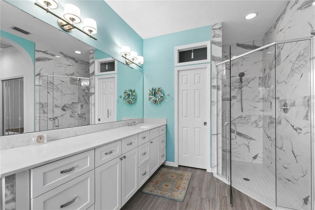 Bathroom, Dual Sink Vanities, Glass Shower, Interior, Marble Walls, Recessed Lighting, Wood Texture Flooring