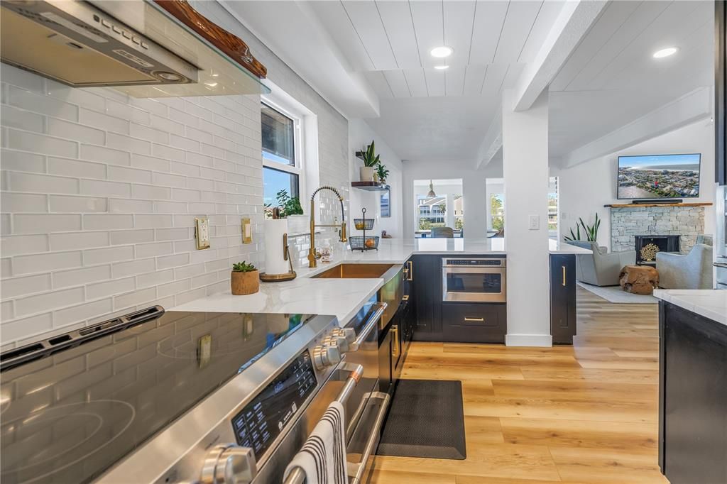 Fireplace, Interior, Kitchen, Recessed Lighting, Stainless Steel Appliances, Stone Walls, Wood Texture Flooring