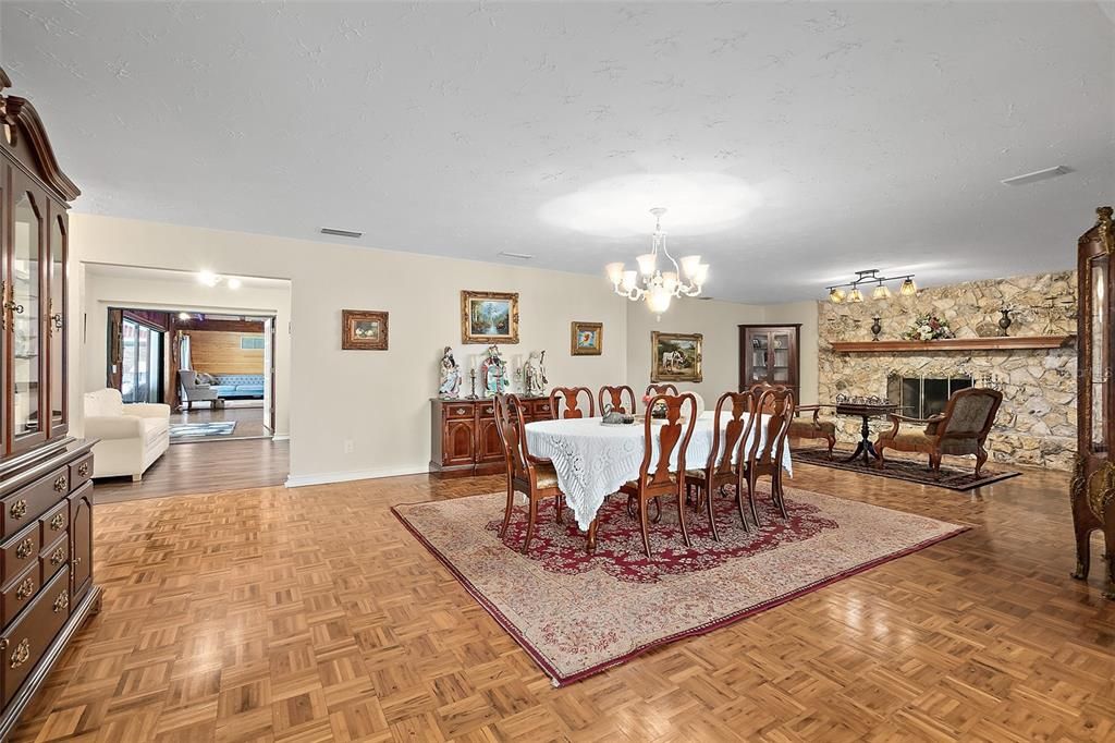 Chandelier, Dining room, Fireplace, Interior, Living room, Stone Walls, Wood Texture Flooring