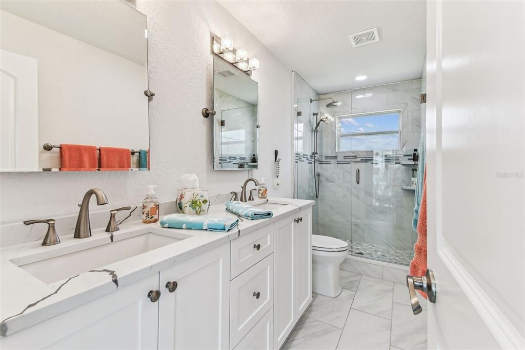 Bathroom, Dual Sink Vanities, Glass Shower, Interior, Marble, Marble Walls, Recessed Lighting
