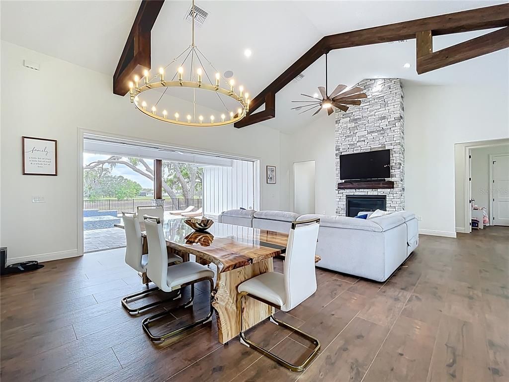 Dining room, Fireplace, Interior, Living room, Pendant Lights, Recessed Lighting, Stone Walls, Wooden Beams, Wood Texture Flooring