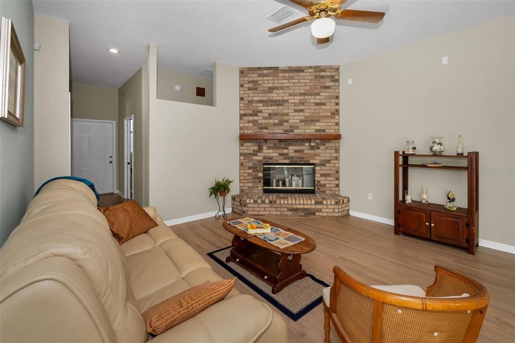 Fireplace, Interior, Living room, Recessed Lighting, Stone Walls, Wood Texture Flooring