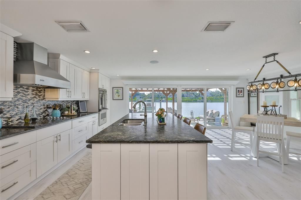 Chandelier, Dining room, Interior, Kitchen, Pendant Lights, Recessed Lighting, Stainless Steel Appliances, Water, Wood Texture Flooring