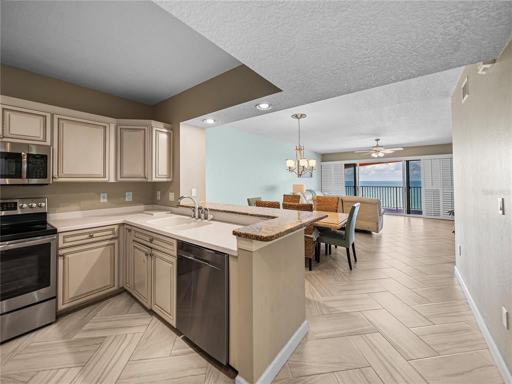 Chandelier, Dining room, Interior, Kitchen, Recessed Lighting, Stainless Steel Appliances, Water, Wood Texture Flooring