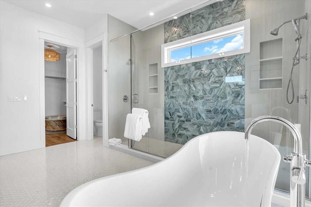 Bathroom, Free Standing Baths, Glass Shower, Interior, Marble Walls, Recessed Lighting, Wood Texture Flooring