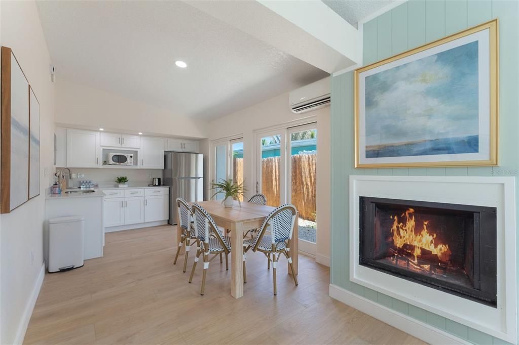 Dining room, Fireplace, Interior, Kitchen, Recessed Lighting, Stainless Steel Appliances, Wood Texture Flooring