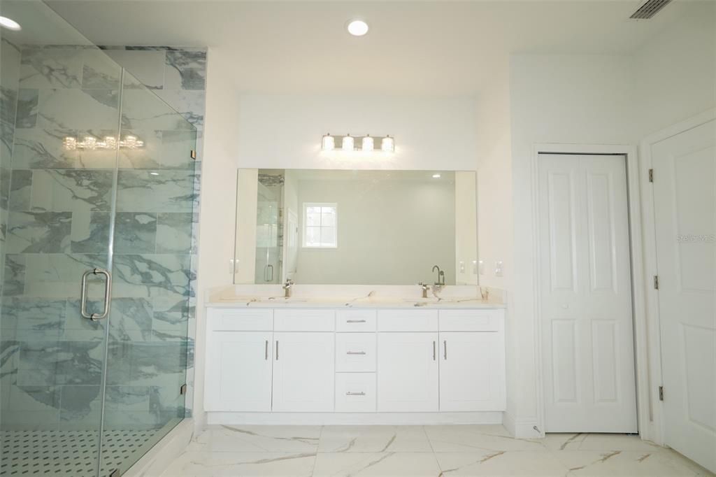 Bathroom, Dual Sink Vanities, Glass Shower, Interior, Marble, Marble Walls, Recessed Lighting