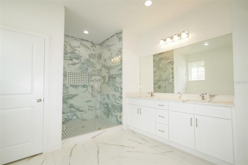Bathroom, Dual Sink Vanities, Glass Shower, Interior, Marble, Marble Walls, Recessed Lighting