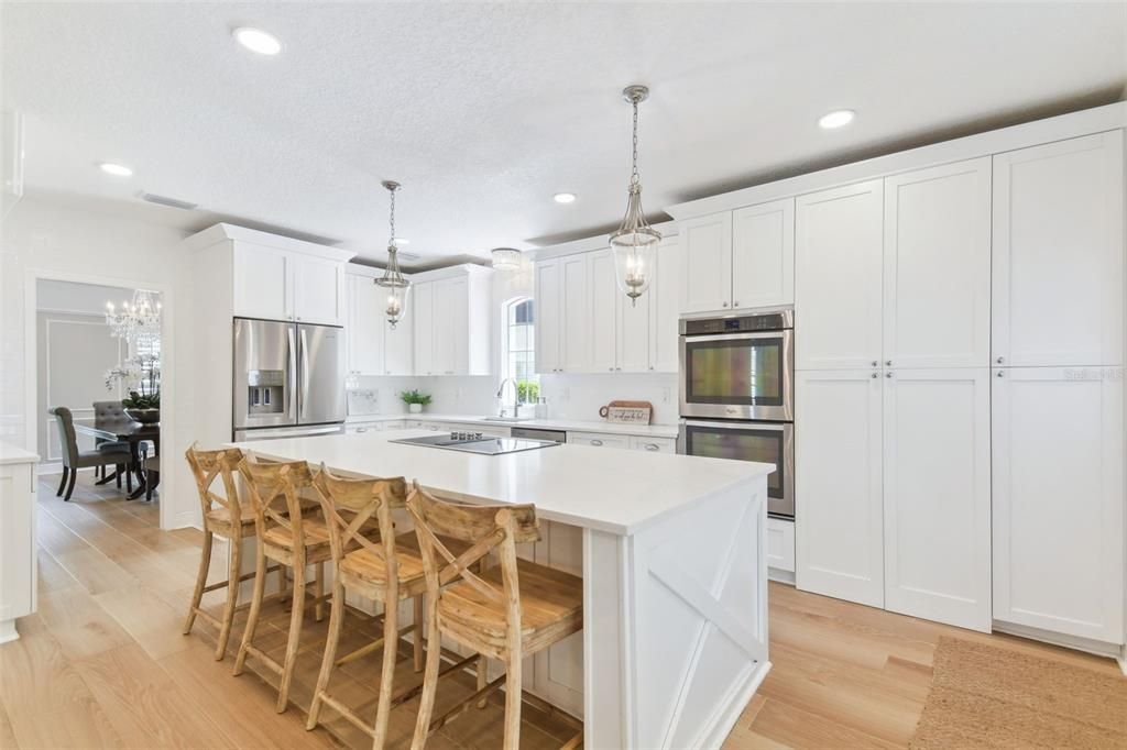 Chandelier, Dining room, Interior, Kitchen, Pendant Lights, Recessed Lighting, Stainless Steel Appliances, Wood Texture Flooring