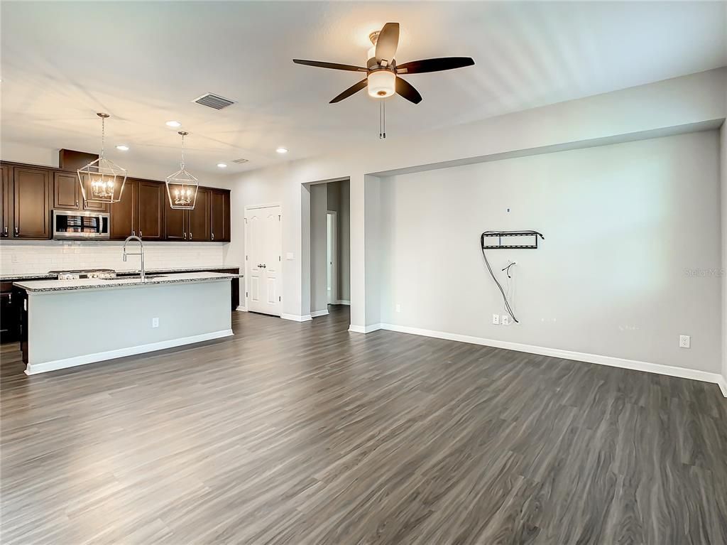 Empty room, Interior, Kitchen, Pendant Lights, Recessed Lighting, Stainless Steel Appliances, Wood Texture Flooring