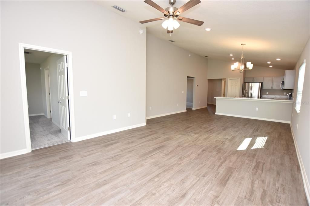 Empty room, Interior, Kitchen, Pendant Lights, Recessed Lighting, Stainless Steel Appliances, Wood Texture Flooring