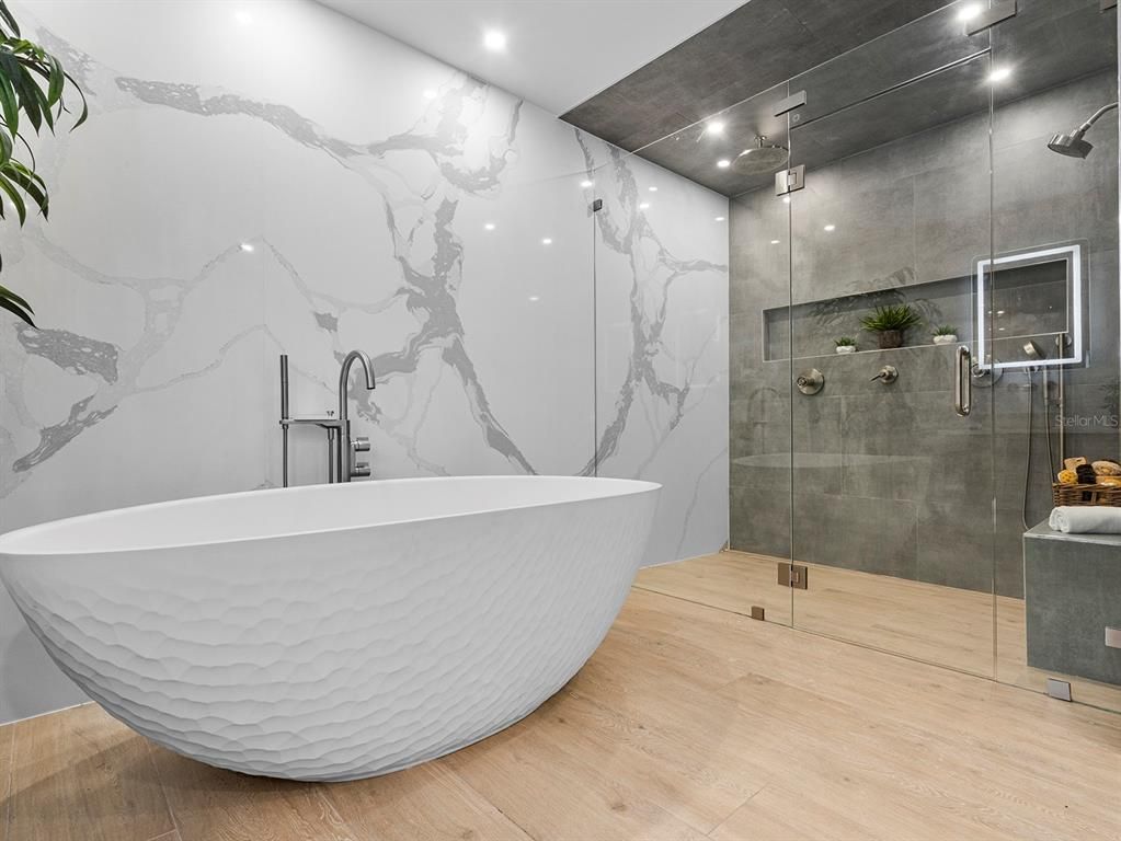 Bathroom, Free Standing Baths, Glass Shower, Interior, Marble Walls, Recessed Lighting, Wood Texture Flooring