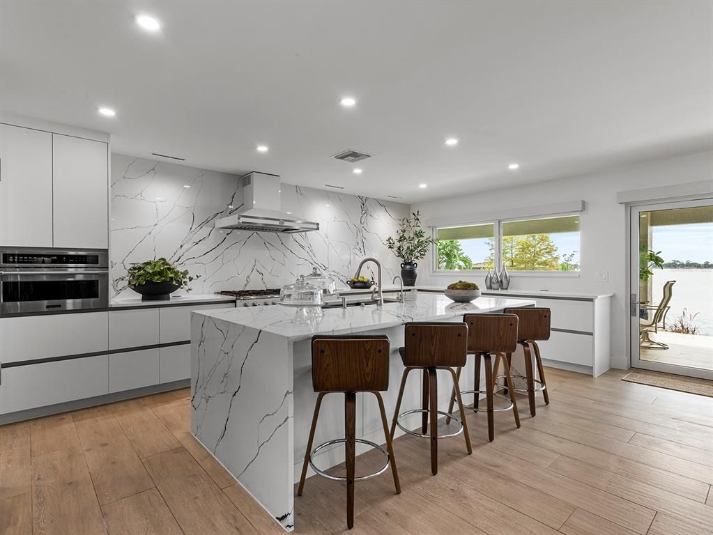 Interior, Kitchen, Marble Walls, Recessed Lighting, Stainless Steel Appliances, Wood Texture Flooring