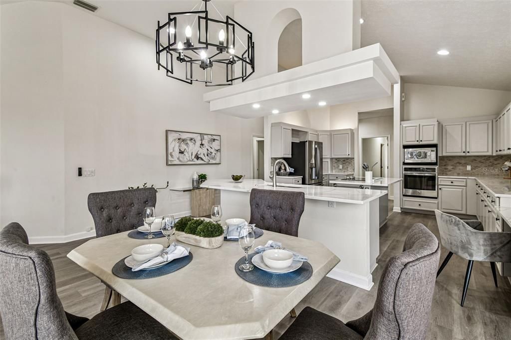 Chandelier, Dining room, Interior, Kitchen, Recessed Lighting, Stainless Steel Appliances, Wood Texture Flooring