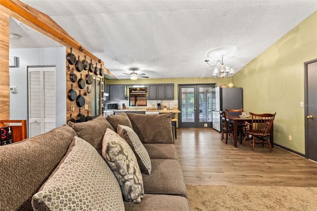Chandelier, Dining room, Interior, Kitchen, Living room, Stainless Steel Appliances, Wood Texture Flooring