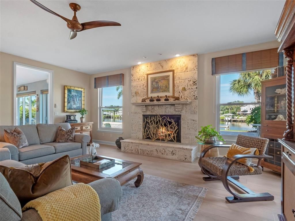 Fireplace, Interior, Living room, Recessed Lighting, Stone Walls, Water, Wood Texture Flooring