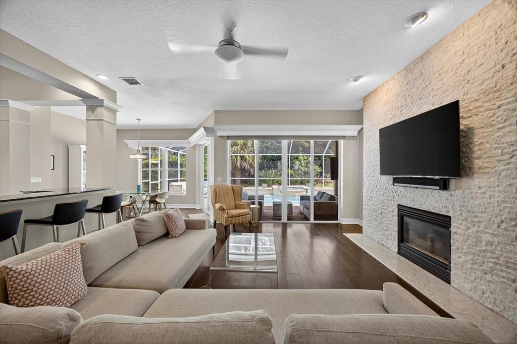 Dining room, Fireplace, Interior, Living room, Pendant Lights, Recessed Lighting, Stone Walls, Wood Texture Flooring