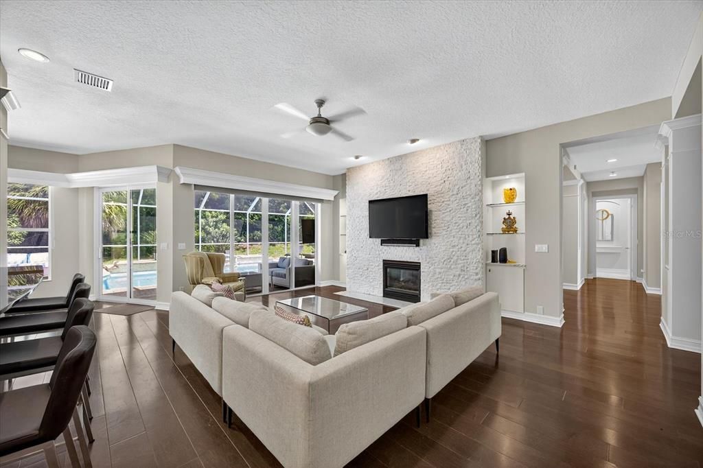Fireplace, Interior, Living room, Recessed Lighting, Stone Walls, Wood Texture Flooring