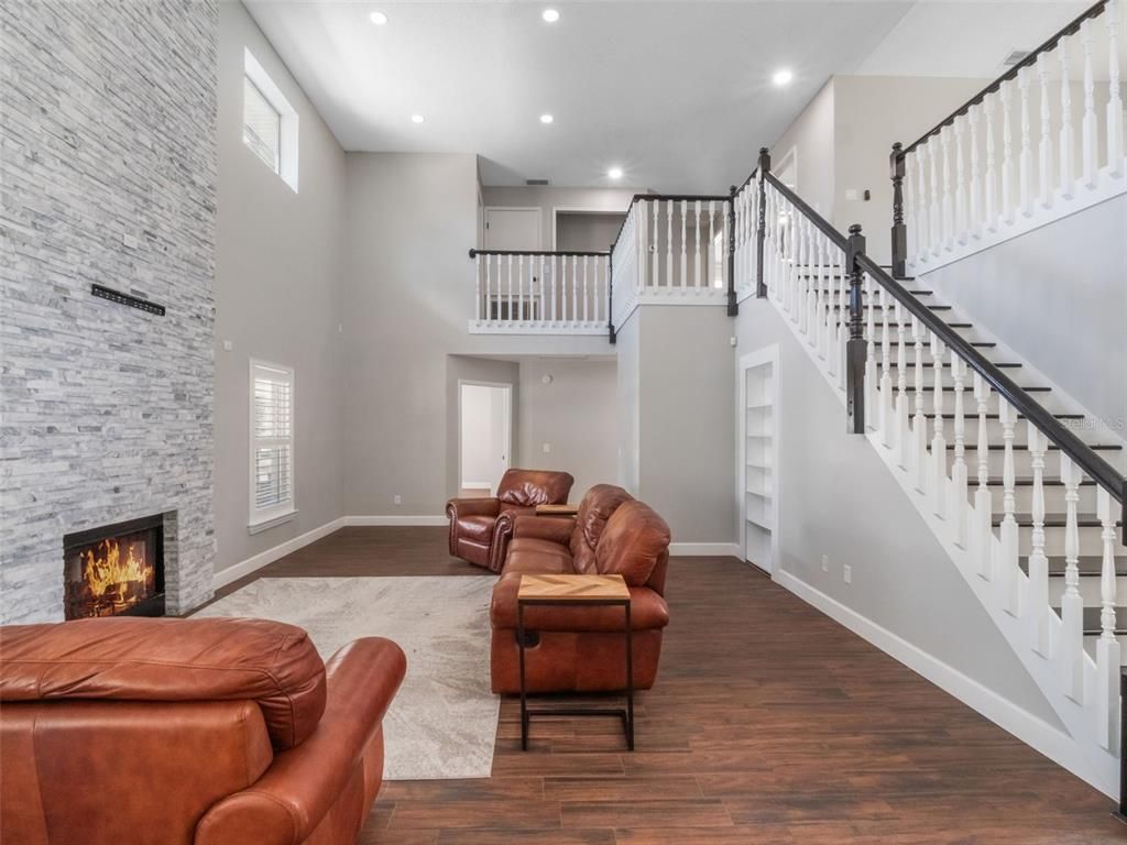 Fireplace, Interior, Living room, Recessed Lighting, Stone Walls, Wood Texture Flooring