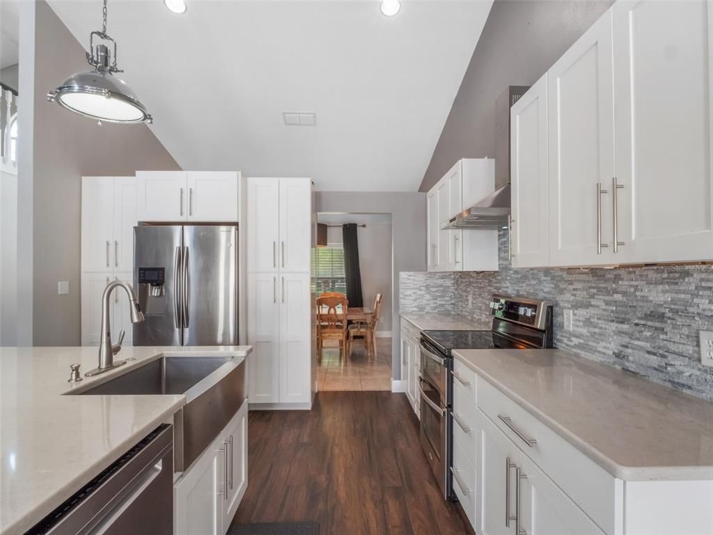 Dining room, Interior, Kitchen, Pendant Lights, Recessed Lighting, Stainless Steel Appliances, Wood Texture Flooring