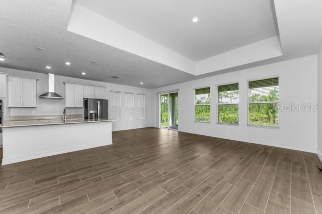 Empty room, Interior, Kitchen, Recessed Lighting, Stainless Steel Appliances, Wood Texture Flooring