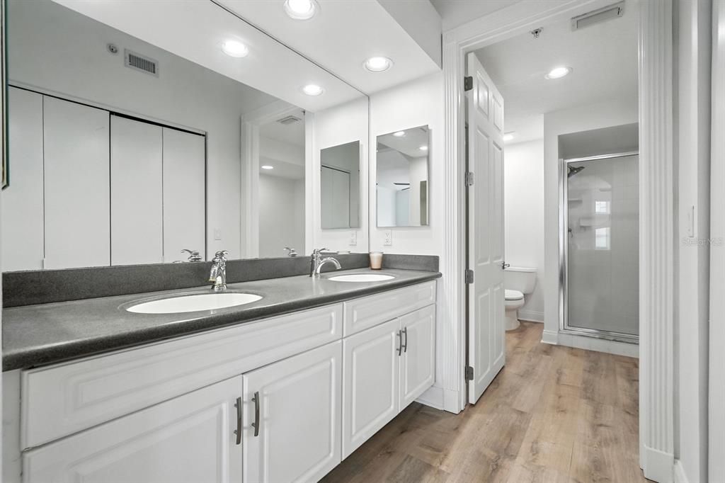 Bathroom, Dual Sink Vanities, Glass Shower, Interior, Recessed Lighting, Wood Texture Flooring