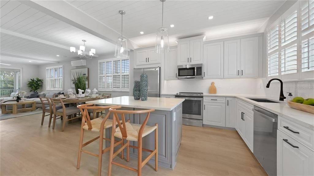 Chandelier, Dining room, Interior, Kitchen, Living room, Pendant Lights, Recessed Lighting, Stainless Steel Appliances, Wood Texture Flooring