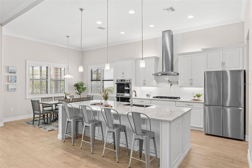 Dining room, Interior, Kitchen, Pendant Lights, Recessed Lighting, Stainless Steel Appliances, Wood Texture Flooring