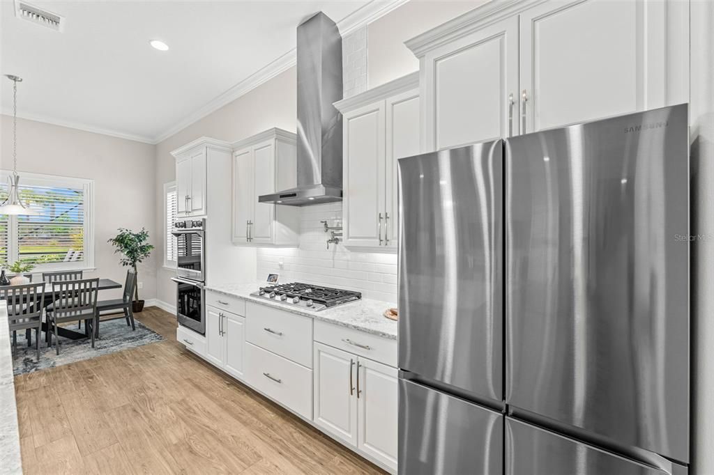 Dining room, Interior, Kitchen, Pendant Lights, Recessed Lighting, Stainless Steel Appliances, Wood Texture Flooring