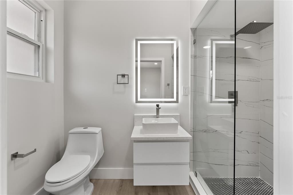 Bathroom, Glass Shower, Interior, Marble Walls, Recessed Lighting, Wood Texture Flooring