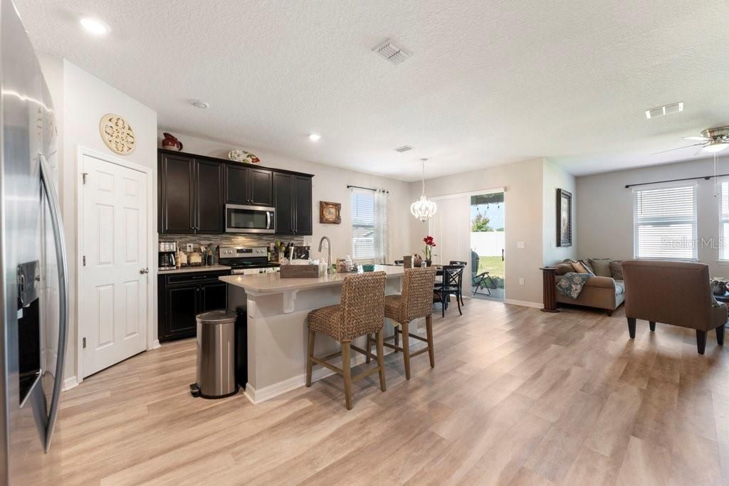 Chandelier, Dining room, Interior, Kitchen, Living room, Pendant Lights, Recessed Lighting, Wood Texture Flooring