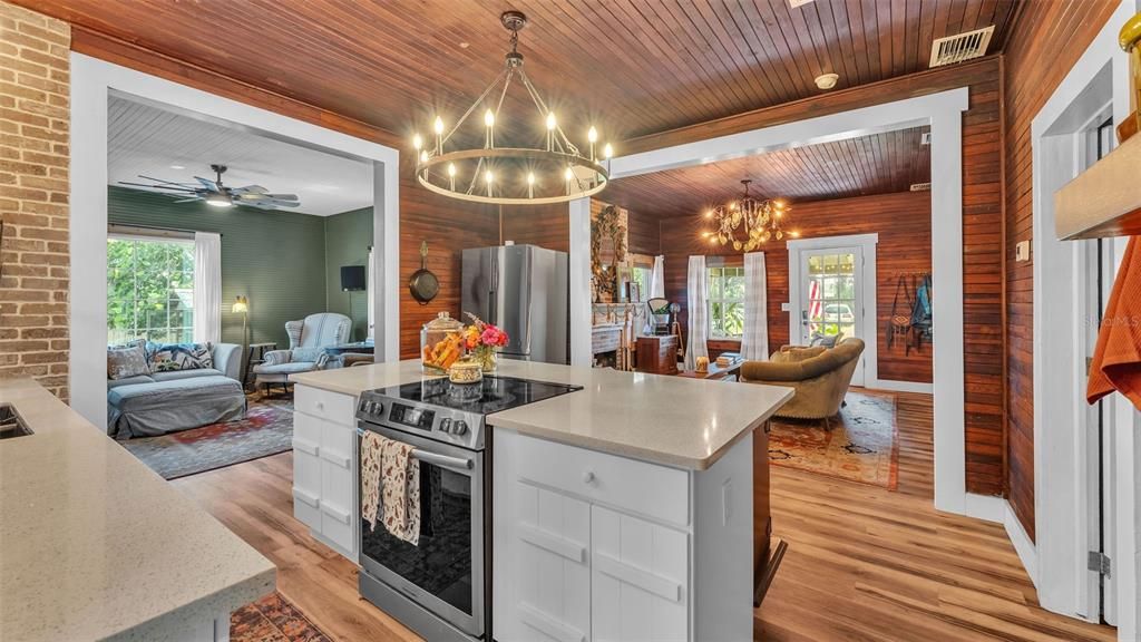 Chandelier, Dining room, Interior, Kitchen, Living room, Pendant Lights, Stainless Steel Appliances, Stone Walls, Wooden Ceilings, Wood Texture Flooring