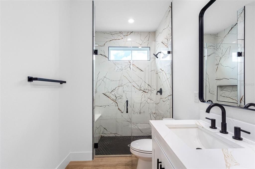 Bathroom, Glass Shower, Interior, Marble Walls, Recessed Lighting, Wood Texture Flooring