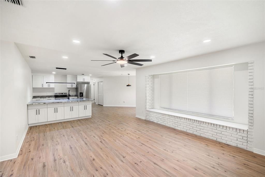 Empty room, Interior, Kitchen, Recessed Lighting, Stainless Steel Appliances, Wood Texture Flooring
