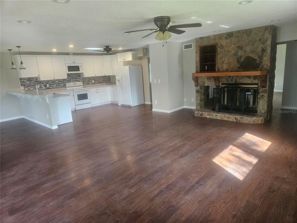 Empty room, Fireplace, Interior, Kitchen, Recessed Lighting, Wood Texture Flooring