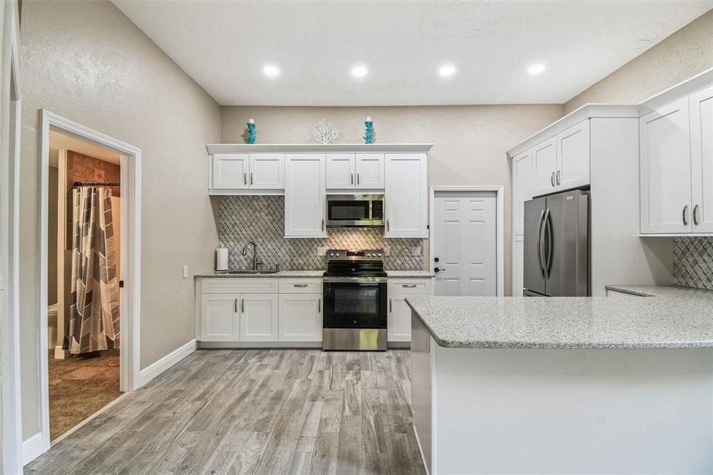Interior, Kitchen, Recessed Lighting, Stainless Steel Appliances, Washer, Wood Texture Flooring