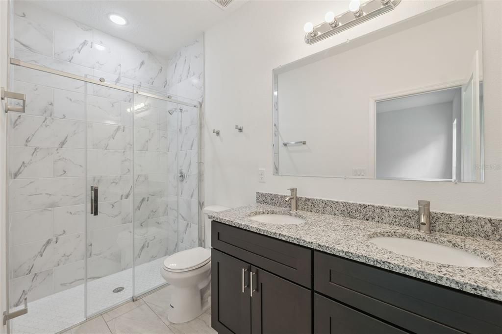 Bathroom, Dual Sink Vanities, Glass Shower, Interior, Marble Walls, Recessed Lighting