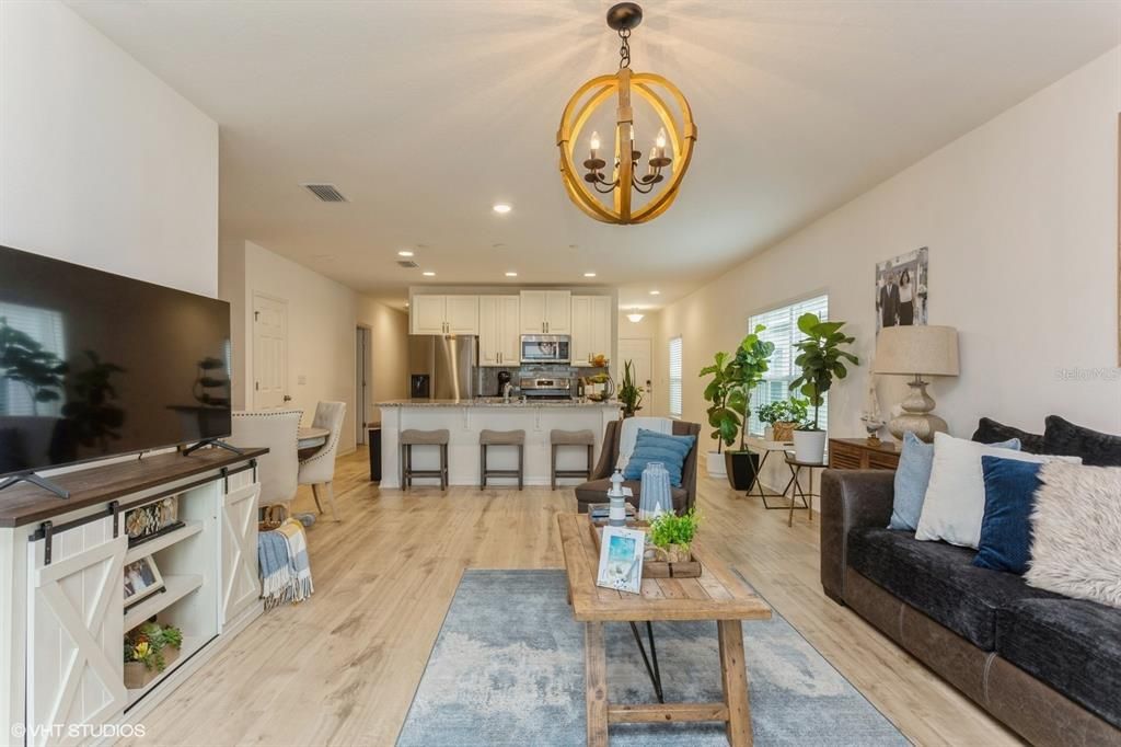 Chandelier, Dining room, Interior, Kitchen, Living room, Pendant Lights, Recessed Lighting, Stainless Steel Appliances, Wood Texture Flooring