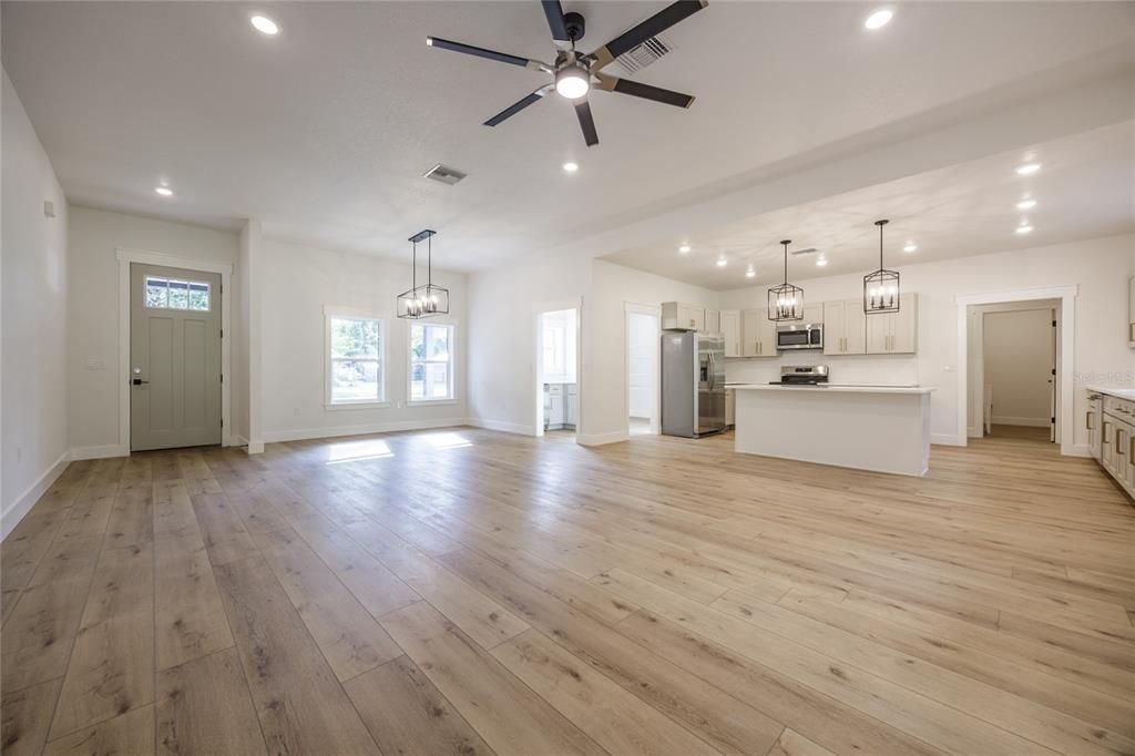 Chandelier, Empty room, Interior, Kitchen, Pendant Lights, Recessed Lighting, Stainless Steel Appliances, Wood Texture Flooring