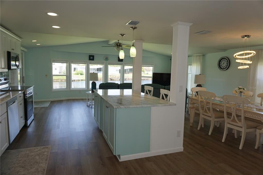 Dining room, Interior, Kitchen, Pendant Lights, Recessed Lighting, Stainless Steel Appliances, Wood Texture Flooring