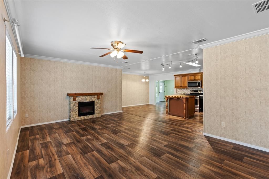 Empty room, Fireplace, Interior, Kitchen, Stainless Steel Appliances, Wood Texture Flooring