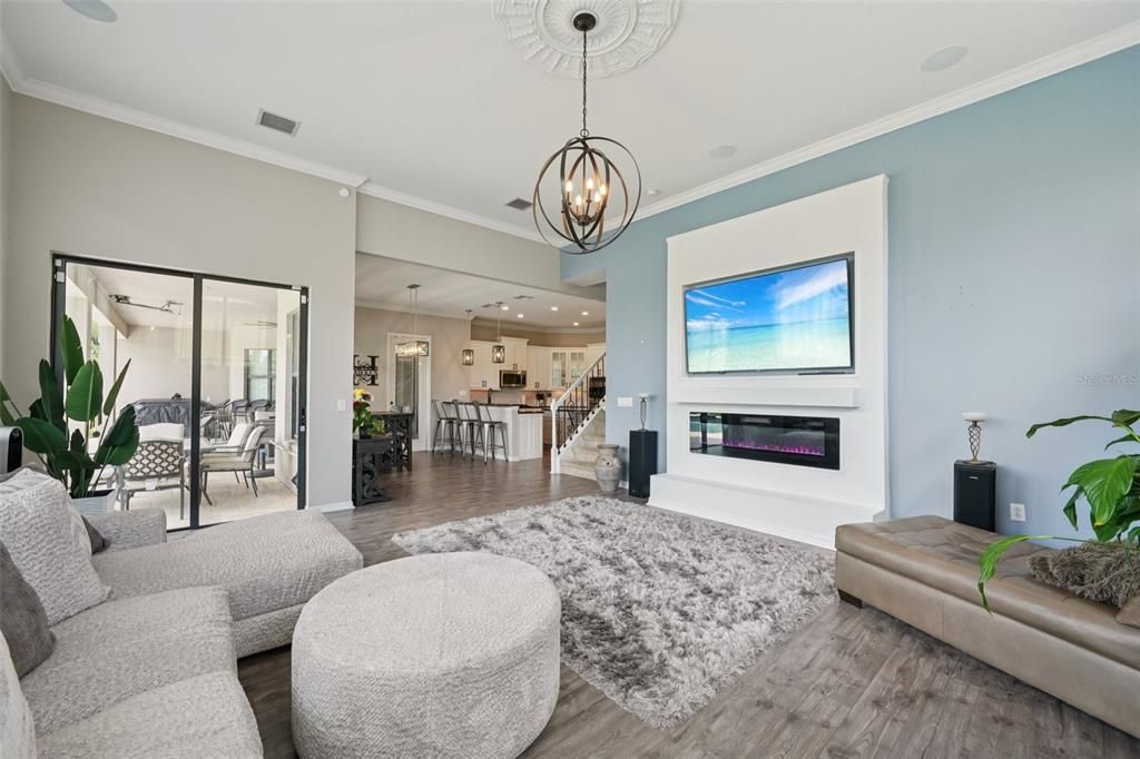 Chandelier, Fireplace, Interior, Kitchen, Living room, Pendant Lights, Recessed Lighting, Wood Texture Flooring