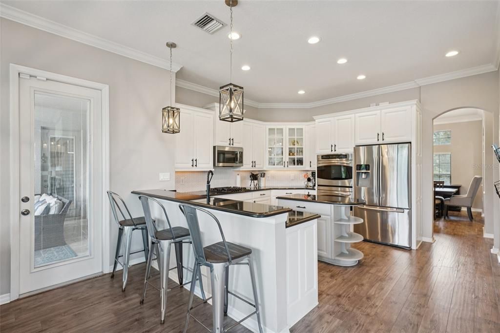 Dining room, Interior, Kitchen, Pendant Lights, Recessed Lighting, Stainless Steel Appliances, Wood Texture Flooring