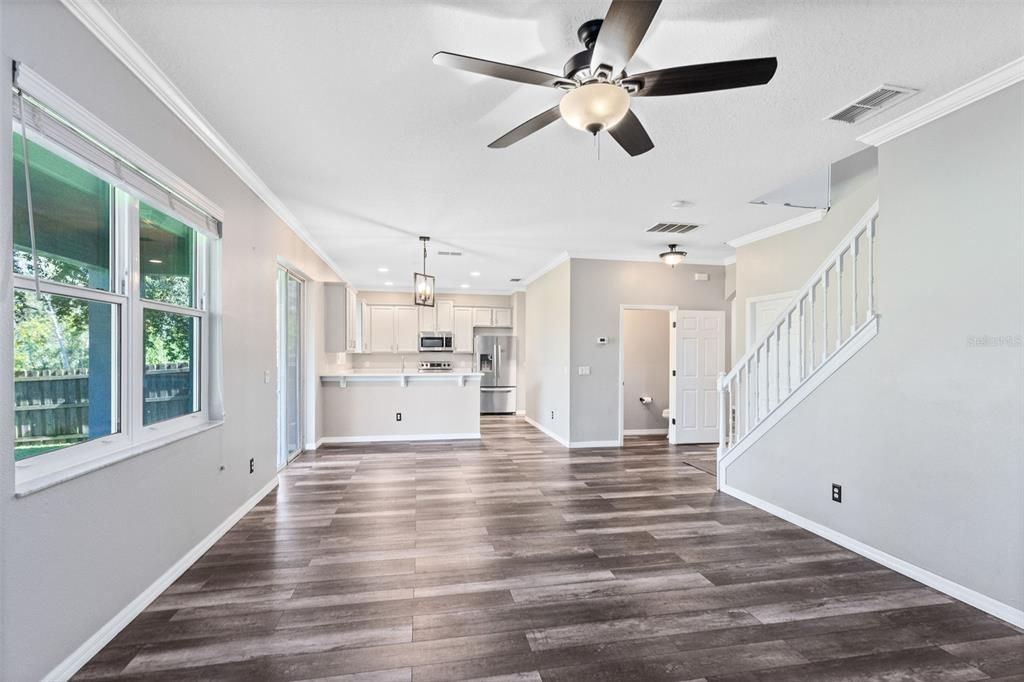Empty room, Interior, Kitchen, Pendant Lights, Recessed Lighting, Stainless Steel Appliances, Wood Texture Flooring