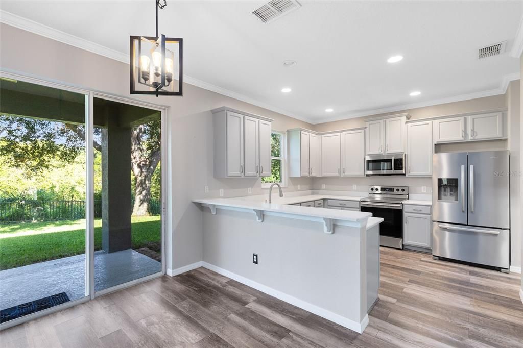 Interior, Kitchen, Pendant Lights, Recessed Lighting, Stainless Steel Appliances, Wood Texture Flooring