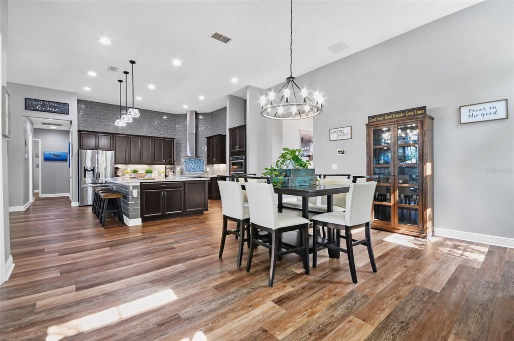 Chandelier, Dining room, Interior, Kitchen, Pendant Lights, Recessed Lighting, Stainless Steel Appliances, Wood Texture Flooring