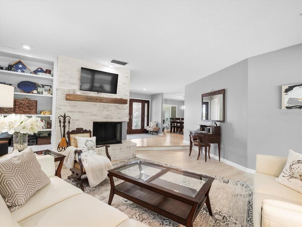 Dining room, Fireplace, Interior, Living room, Recessed Lighting, Stone Walls, Wood Texture Flooring