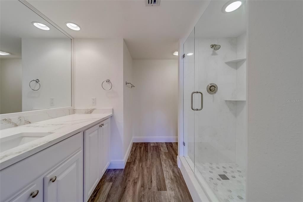 Bathroom, Dual Sink Vanities, Glass Shower, Interior, Recessed Lighting, Wood Texture Flooring