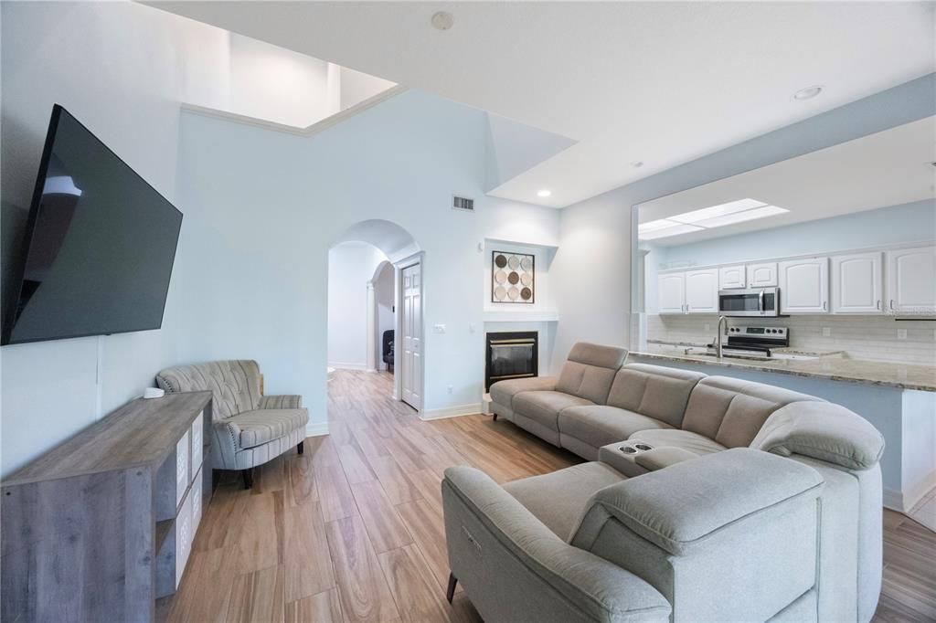 Fireplace, Interior, Kitchen, Living room, Recessed Lighting, Stainless Steel Appliances, Wood Texture Flooring